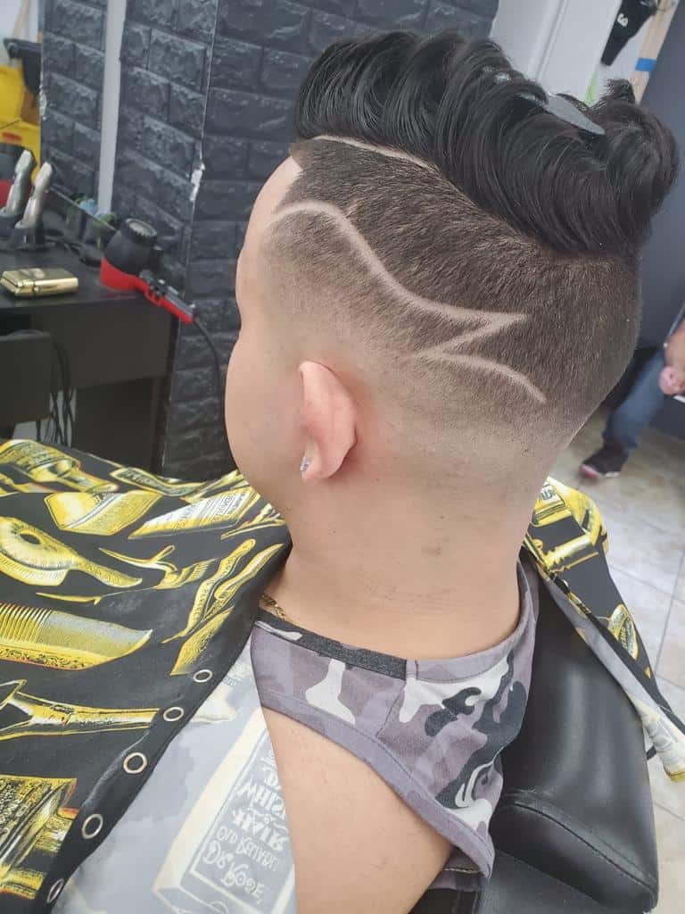 Burst fade with a curved hair-design line and volume on top
