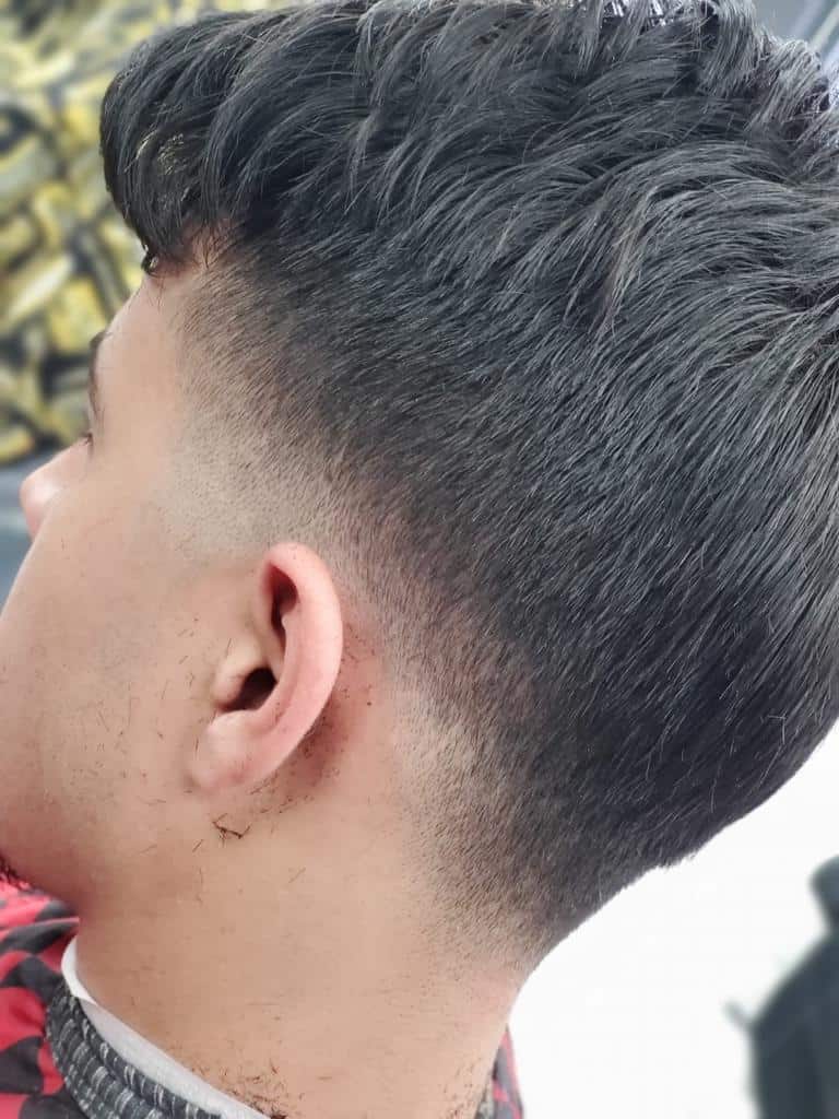 Low taper fade with a soft side-swept top