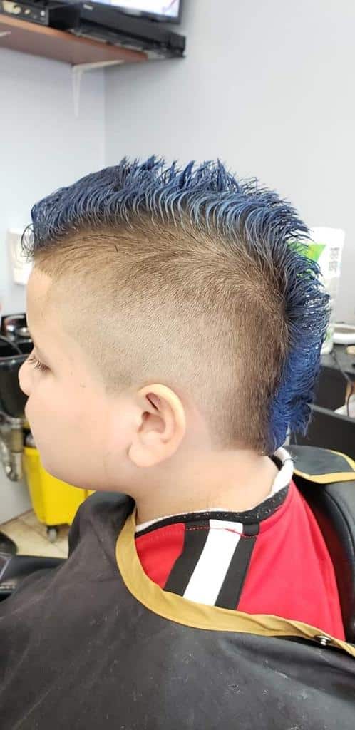 Kid's mohawk with a high skin fade and blue-dyed spikes