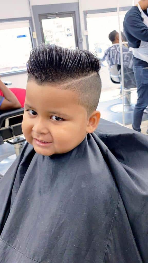 Kid's pompadour with a razor part and low fade